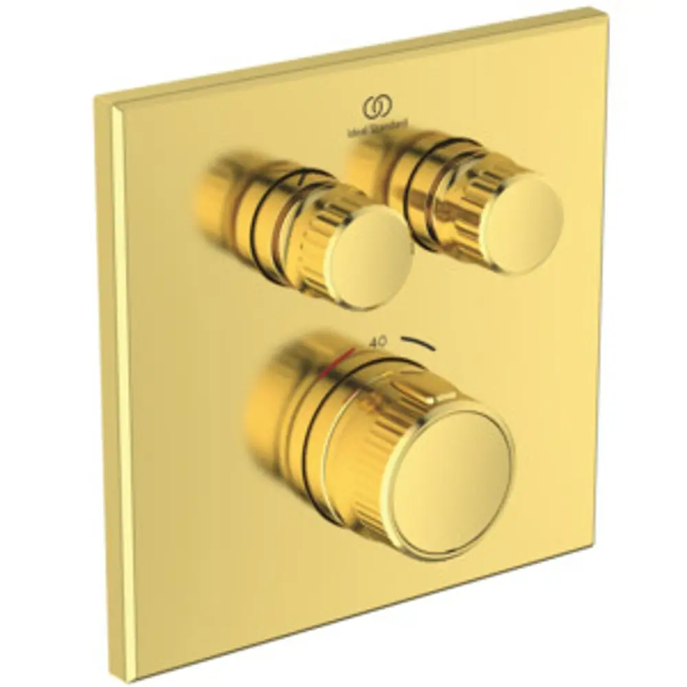 Brausethermostat mit drei regulierbaren Knöpfen in gebürstetem Gold-Finish, montiert auf einer quadratischen Plattenoberfläche. Ideal Standard-Logo sichtbar.